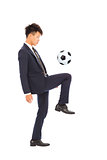 businessman is kicking a soccer