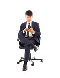 asian businessman touching smart phone on chair