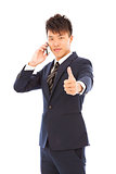 young businessman talking on the phone with thumb up