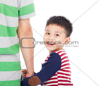 Little boy holding the hand of the father and looking back