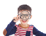 adorable boy holding a magnifier and watching through
