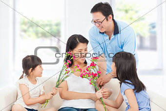 Daughters and father celebrating mother's day