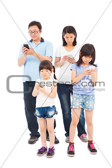 Asian Family standing and using smart phone together