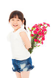 Smiling girl hiding a bouquet of carnations