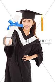 young woman college graduate wearing cap and gown holding diplom