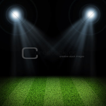 Night football arena illuminated by spotlights
