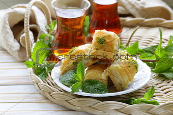 traditional Turkish arabic dessert - baklava with honey and pistachios