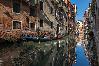 Traditional Venice Gandola Ride along Narrow Canal, Venice, Ital