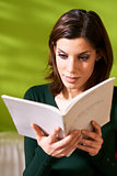 girl studying literature with book at home