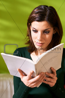girl studying literature with book at home