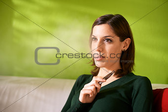 young woman smoking electronic cigarette at home