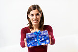 happy girl holding gift box to the camera