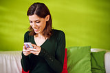 portrait of girl reading sms on smarthphone at home
