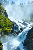 Summer Latefossen waterfall on mountain slope (Norway).