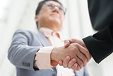 Asian business men handshaking