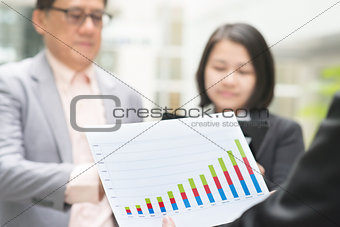 Business executive presenting charts to CEO