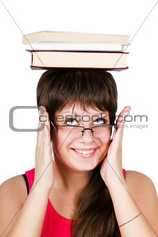 young beautiful girl in glasses with books on head. isolated on 