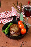 grilled meat beef steak with vegetable garnish (asparagus and tomatoes)