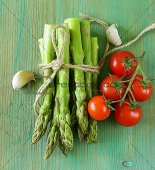 fresh green organic asparagus on a wooden background