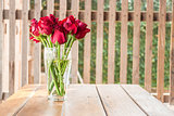 Group of red roses on wooden table 