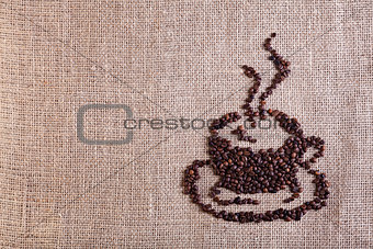 Coffee cup made of beans on burlap background