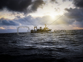 Fishing ship in strong storm.
