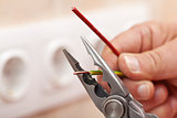 Pliers peeling copper wires - closeup