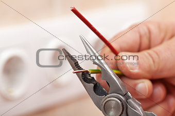 Pliers peeling copper wires - closeup