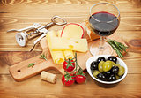 Red wine with cheese, olives, bread, vegetables and spices