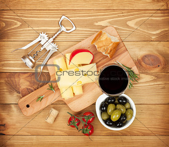 Red wine with cheese, bread, olives and spices