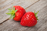 Ripe strawberries over wooden table background