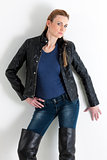 portrait of standing woman wearing jeans and black jacket