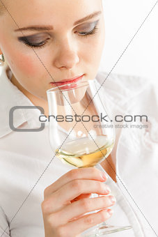 portrait of young woman tasting white wine