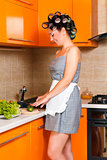 middle-age beautiful woman in the kitchen with knife