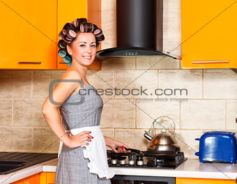 middle-age woman with apron in the kitchen