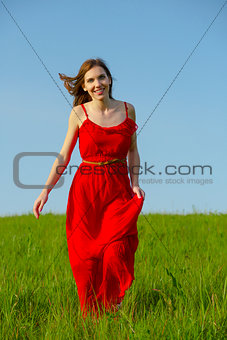 Beautiful girl walking with a red dress