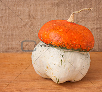 decorative pumpkin (Cucurbita pepo) on a wooden table