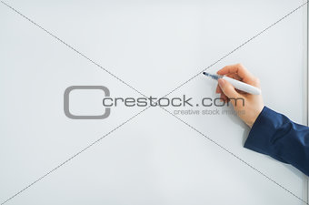 Closeup on business woman writing in flipchart