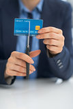Closeup on business woman cutting credit card with scissors