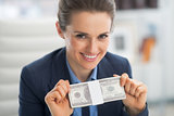 Portrait of happy business woman showing money pack