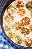 Meatballs cooked in cheese sauce