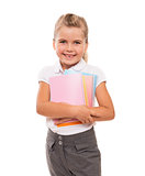 joyful little girl standing on white with few colorful notebooks
