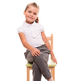 little girl sitting on a chair and smiling