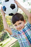 Cute Young Boy Playing with Soccer Ball in Park