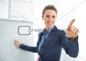Business woman near flipchart pointing