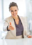 Closeup on smiling business woman stretching hand for handshake