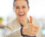 Closeup on happy business woman showing thumbs up
