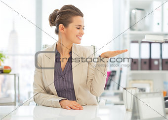 Business woman presenting something on empty palm