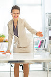 Smiling business woman offering to sit