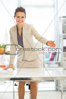 Smiling business woman offering to sit